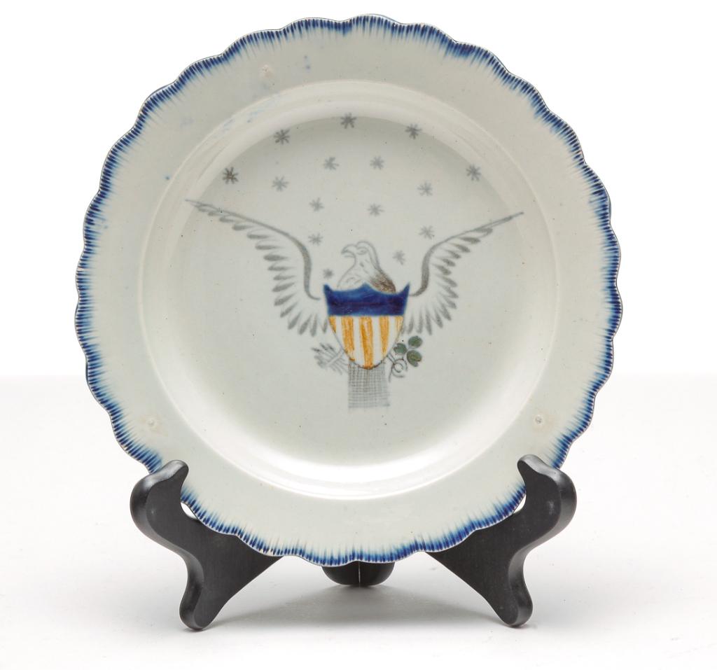 ENGLISH LEEDSWARE EAGLE PLATE.: First half 19th century. Scalloped blue feather edge with four color American eagle with shield. Eagle has faded to light grey rather than brown. Faint knife scratches and minor edge flaking. 8"d.