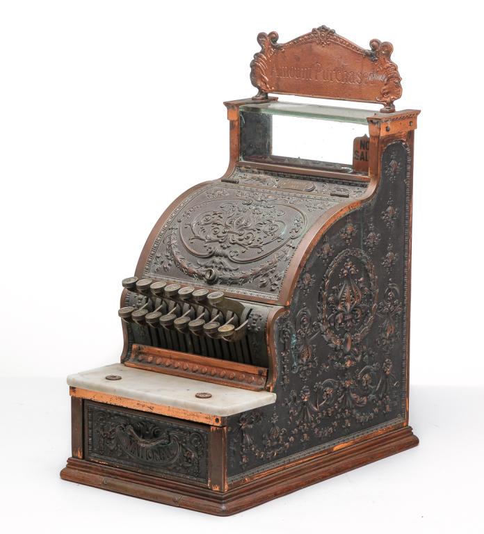 AMERICAN CANDY STORE NATIONAL CASH REGISTER.: Ca. 1900. Small size with heavily cast floral case, marble shelf and oak base. "Amount Purchased" sign at top is well executed reproduction. Serial number 1329038 & 313. Some verdigris. 21.5"h. 10.25"