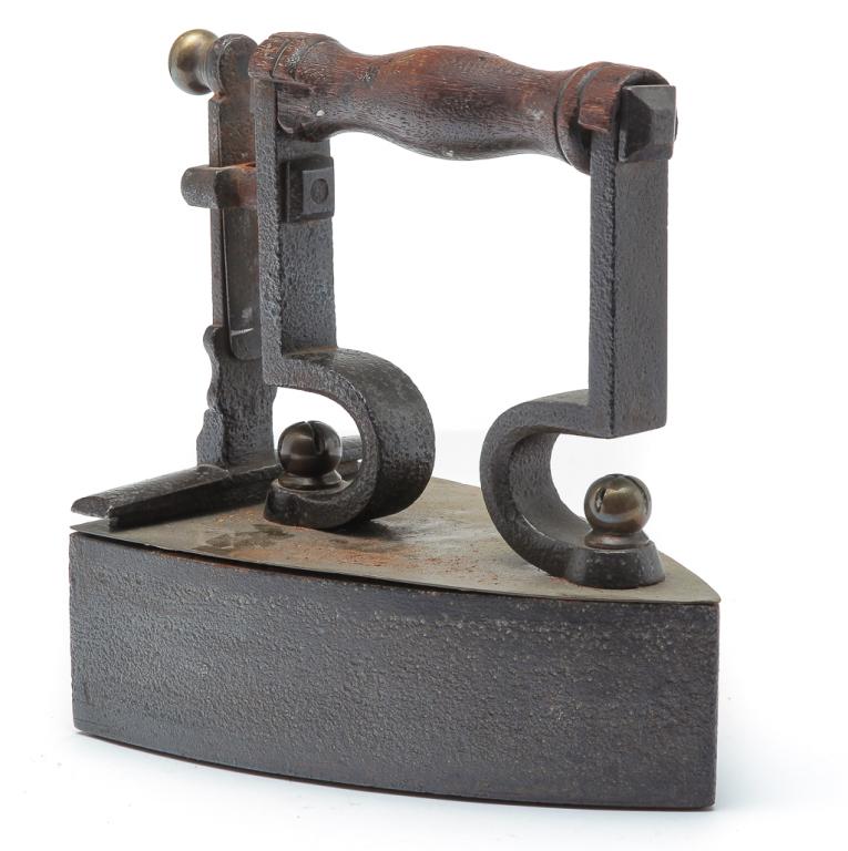 EUROPEAN BOX TYPE CLOTHING IRON.: Second quarter 19th century. Cast iron with brass and oak handle. Nice detail with minor wear. Missing insert. 8"h.