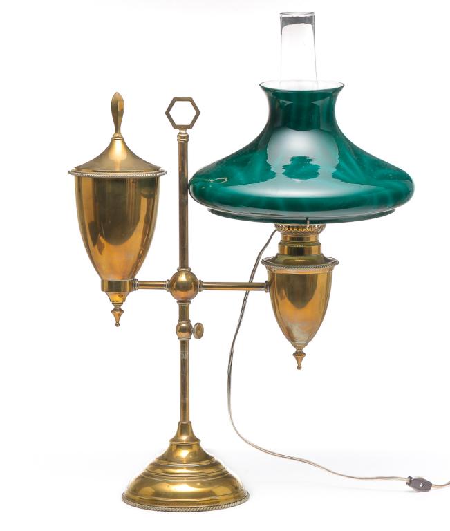 AMERICAN BRASS STUDENT LAMP.: Fourth quarter 19th century. Adjustable height, clear chimney and an old green patterned cased glass shade. 21.5"h. 18"w. Shade has 10" fitter.