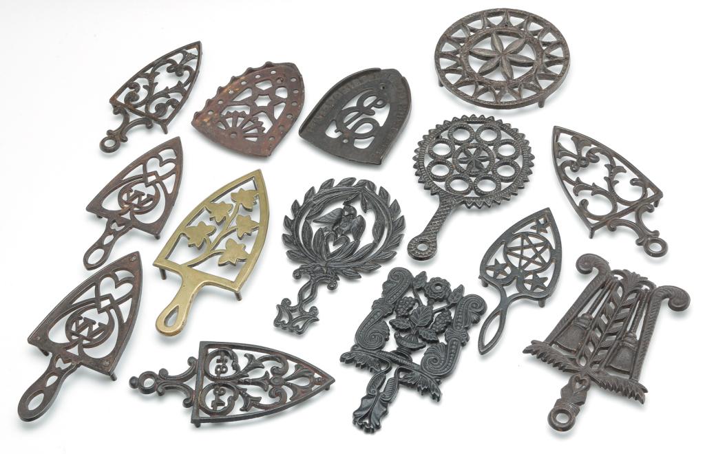 FOURTEEN AMERICAN CAST TRIVETS.: Nine 19th century cast iron, one 19th century cast brass and four contemporary cast iron.