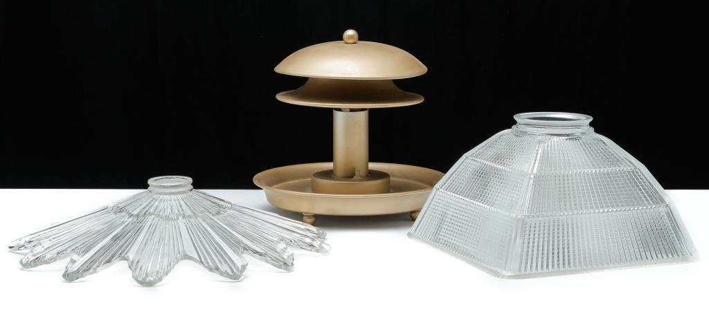 THREE PIECES OF CONTEMPORARY LIGHTING.: Mid 20th century. Industrial desk lamp, pressed sheet metal with domed top, dish shaped base and ball feet. 10.5"h. And two clear glass diffusers. Snowflake shape, 3.75"h. 16"d. and square with rounde