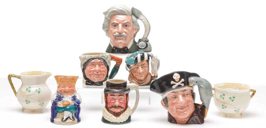 EIGHT PIECES OF UNITED KINGDOM CHINA.: Twentieth century. Belleek kettle shaped creamer and sugar. And six toby jugs. Three are Royal Doulton. "Long John Silver", "Mark Twain" and "The Falconer", one Burlingtonware "Old King Cole" and two 