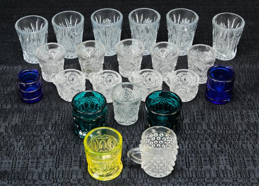 APPROXIMATLEY FIFTY MISC. STEMS AND SHOT GLASS.: 20th century. Nine cordials with ruby bowls and clear stems, five pink depression glass stems, nine Heisey "Orchid" stems, three panel-cut cordials with teardrop stems, two martini glasses with racing