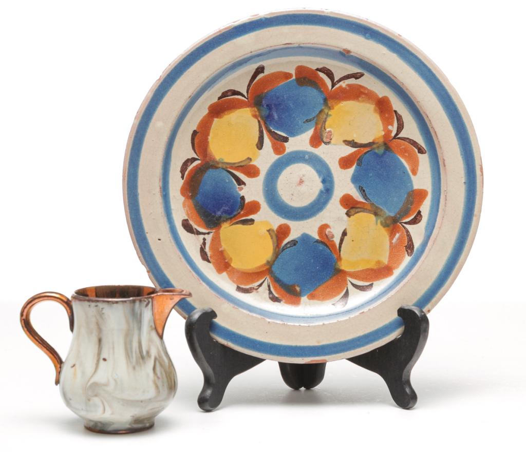 TWO PIECES OF EUROPEAN REDWARE.: Mid 19th century. English copper luster creamer with marbleized decoration. 3"h. And a plate with blue, yellow, rust and tan decoration. 8"d.