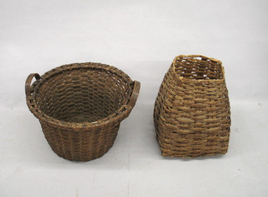 TWO WOVEN SPLINT BASKETS. Both have a natural brow: TWO WOVEN SPLINT BASKETS. Both have a natural brown patina. Large round example with flared sides and raised handles. 20 1/2"d. 14 1/2"h. Primitive tall basket with square base and top. 17"h. Both hav
