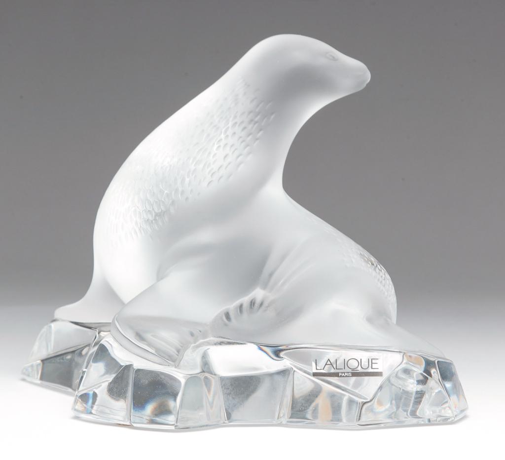 FRENCH "LALIQUE" GLASS SEA LION "OTARIE".: Second half-20th century. Sea lion on clear rocks. Etched script "Lalique, France" and sticker labels.5.25"h.