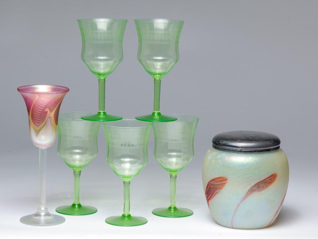 SEVEN PIECES OF GLASSWARE.: American and European, 20th century. Loetz type art glass biscuit jar with lid, 6.25"h., five etched green glass wines (chip), 6.5"h. and an art glass wine glass signed "Carrier", 8.75"h.
