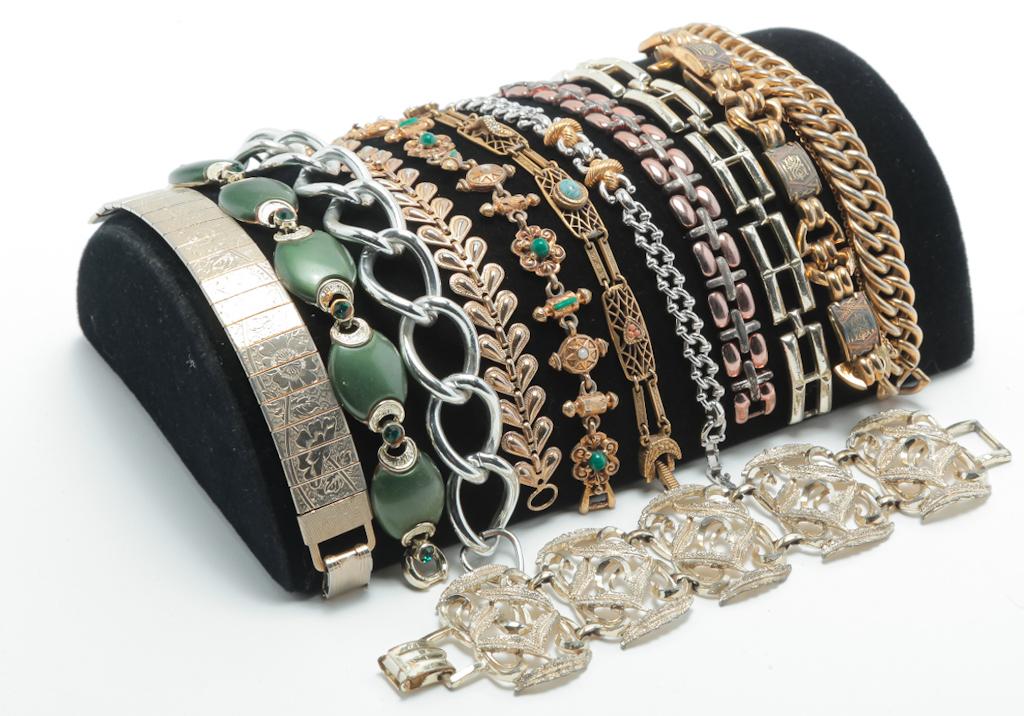 TWELVE VINTAGE FLEXIBLE LINK BRACELETS.: Mid-late 20th century. Very wearable group of flexible link bracelets in a variety of styles, several embellished with stones or engraving. Lengths range from 7"- 8". Marked pieces by Avon, LCi, Golde