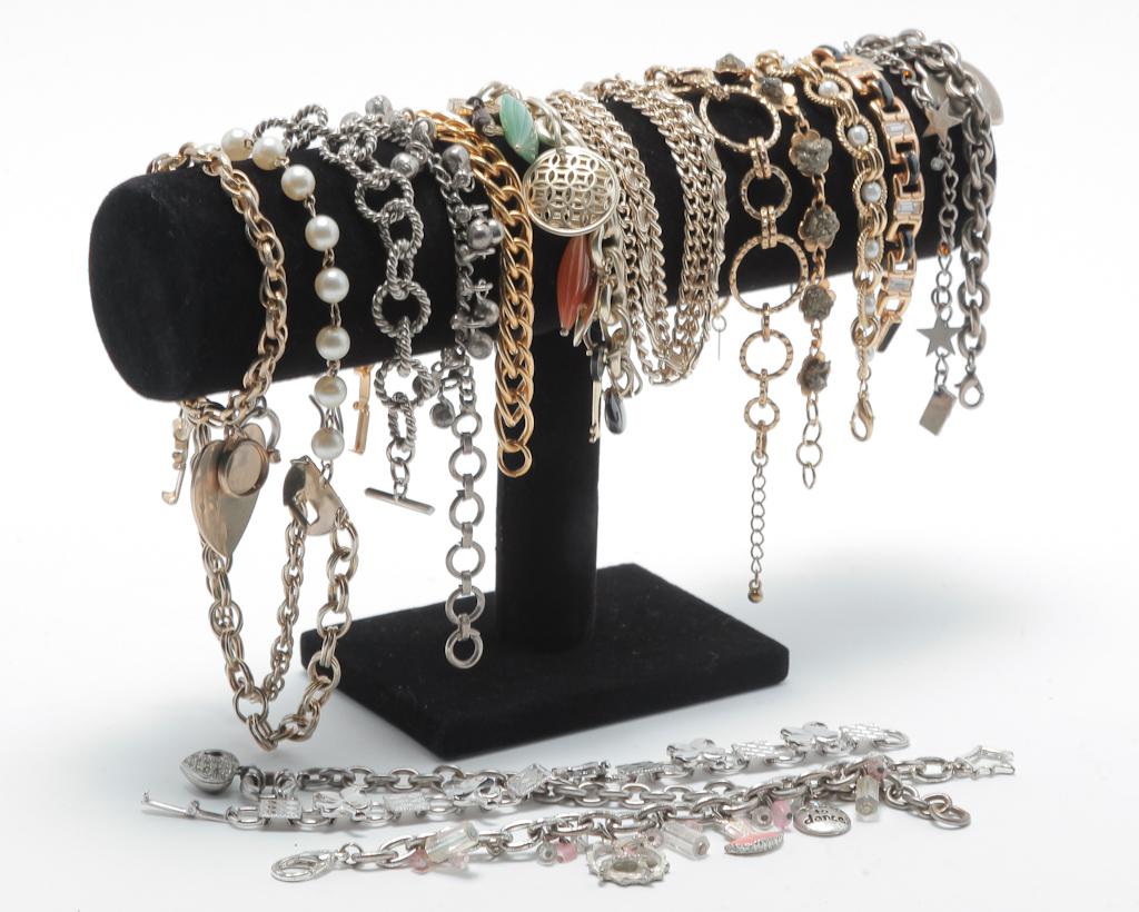 VINTAGE FLEXIBLE LINK BRACELETS.: Mid-late 20th century. Sixteen silver and gold tone bracelets - each one different., several charm bracelets, one ankle bracelet. Clasp missing on one charm bracelet.