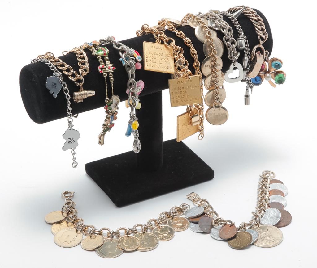 TWELVE VINTAGE COSTUME CHARM BRACELETS. (1 of 3)