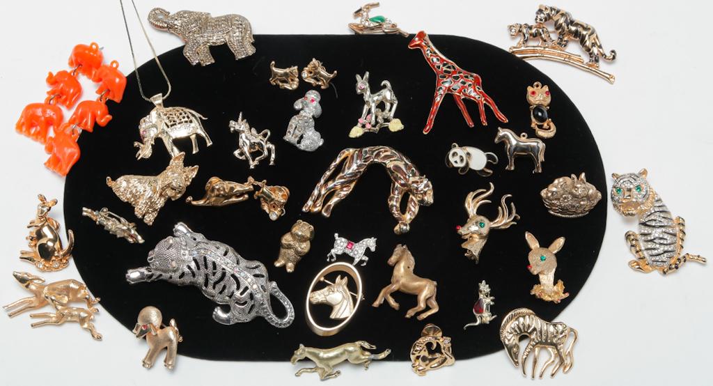 A MENAGERIE OF ANIMAL JEWELRY.: Mid 20th - early 21st century. Elephants, tigers, zebras, giraffes, horses, kangaroos and more. Thirty-three pieces of gold and silver tone animal jewelry, some with rhinestones or enamel. Signed piec