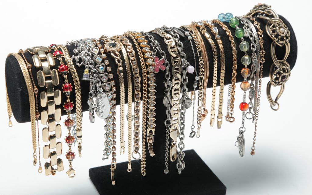 BOUNTY OF BRACELETS.: Mid-late 20th century. Twenty-eight easy to wear bracelets â€“ charm bracelets, tennis style bracelets, fancy link bracelets and more. Includes gold and silver tone in a variety of lengths.