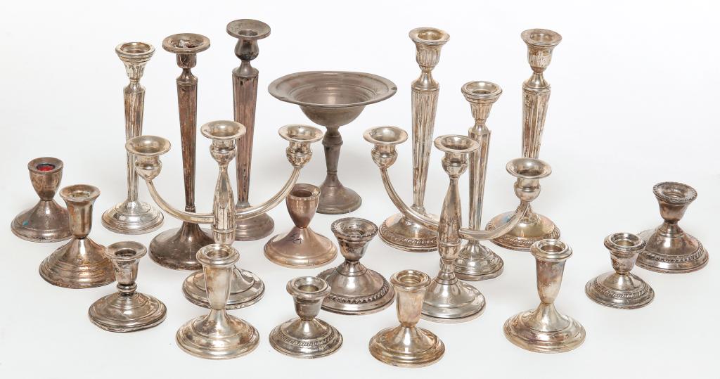 GROUP OF AMERICAN WEIGHTED STERLING.: Twentieth century. Tall and low candle sticks, one pair of three branch candelabra and a small compote. Dents and damage.