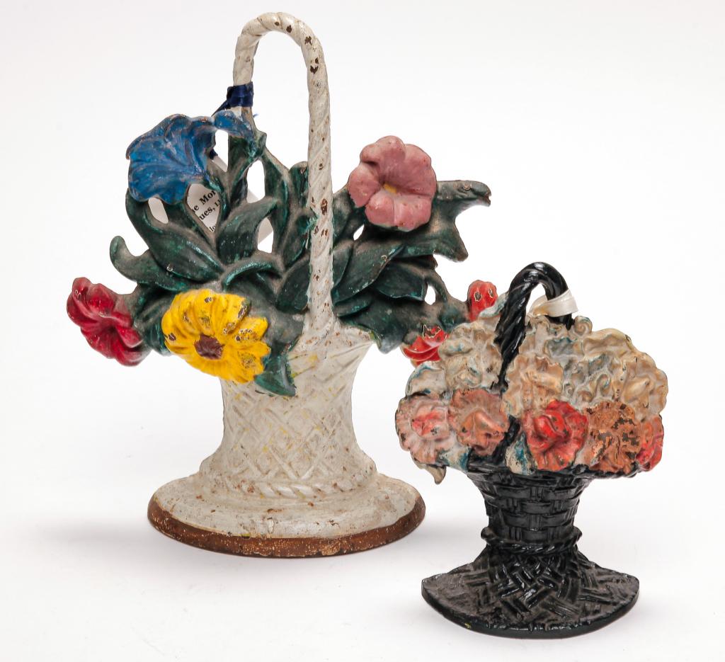 TWO FLOWER BASKET DOORSTOPS INCLUDING HUBLEY: Two flower basket doorstops, the larger being made by Hubley. 6" and 10" high.