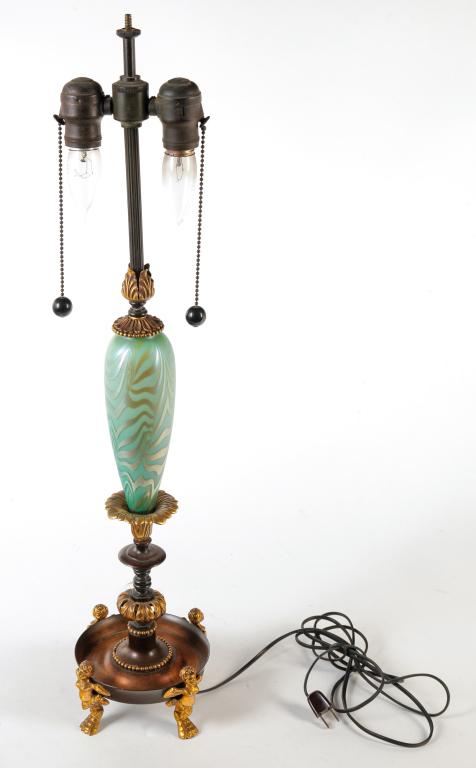 AMERICAN "KING TUT" DURAND ART GLASS LAMP.: First half 20th century. Unsigned with iridized glass insert and Classical style gilded and patinated brass fittings. 28.25"h.