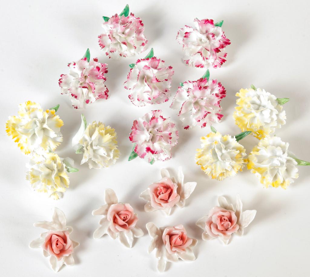SEVENTEEN PORCELAIN FLORAL PLACE-CARD HOLDERS: Group of seventeen porcelain floral place-card holders. Includes six yellow flower card holders and eleven pink flower card holders.