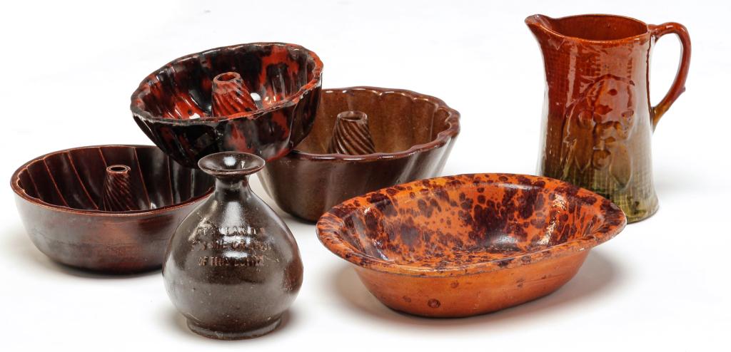 SIX PIECES OF EARTHENWARE.: Nineteenth and 20th centuries. Three Turk's head molds, 3.75"h. 3.25"h. and 2.75"h. Red wave oval dish 3"h. Pitcher with embossed decoration, 8.25"h. And bottle with bulbous body, 6.25"h.