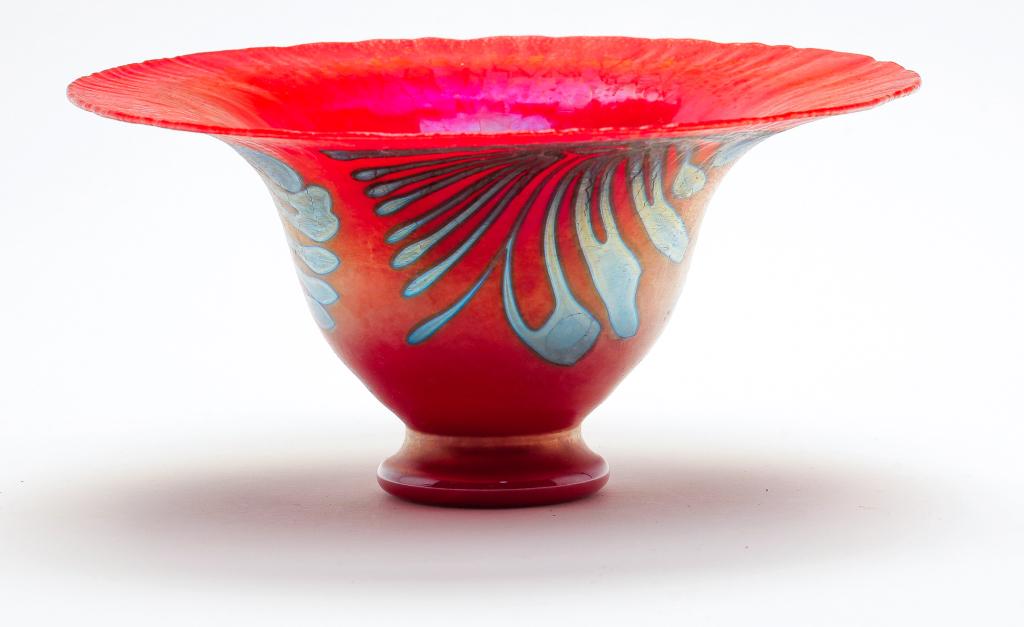 CHARLES LOTTON RED GLASS BOWL.: Signed and dated "1980". Footed bowl, possibly Mandarin red, with wide stretch iridized rim and wisteria pattern. 3.5"h. 7.5"d.