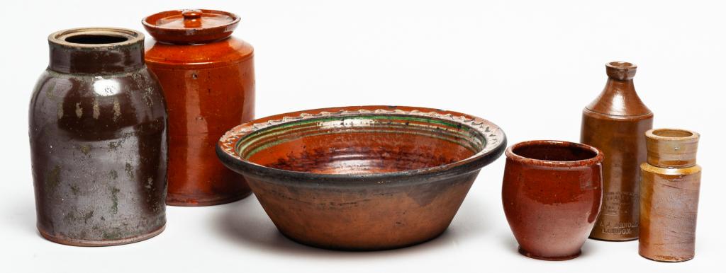 SIX PIECES OF REDWARE AND STONEWARE.: Nineteenth century. English stoneware jar and bottle with impressed labels. Partial "Black", 5"h., and "...J. Bourne & Son...Denby Pottery...R&J Arnold, London", 7.25"h. And four American pieces. Redw