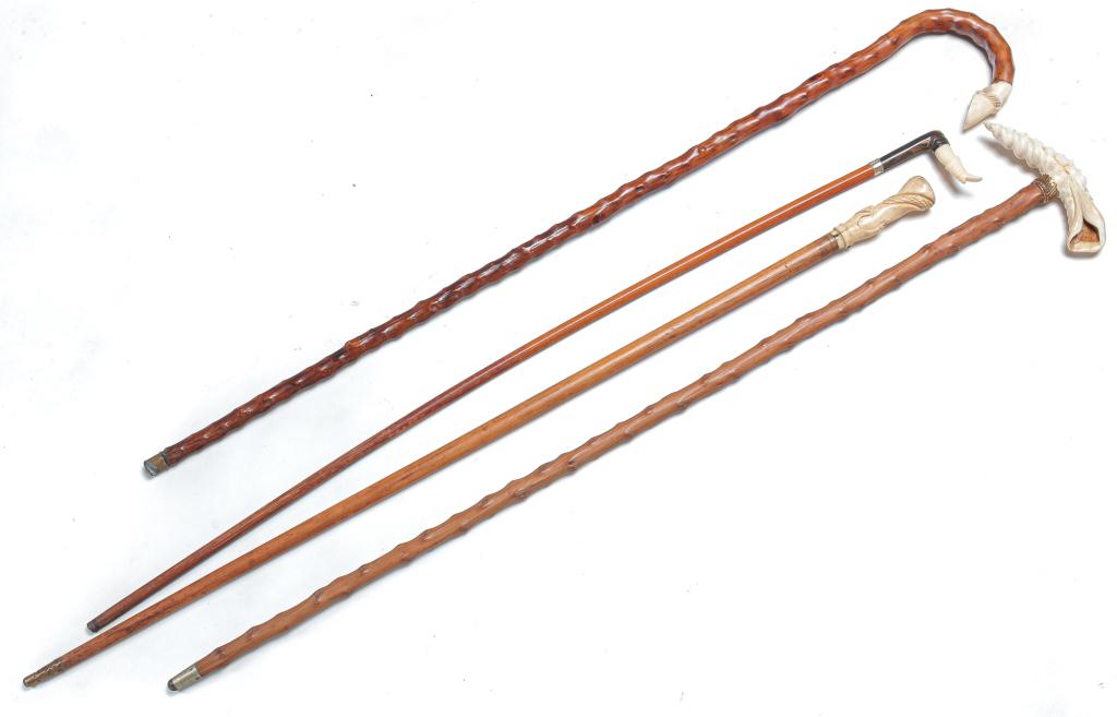 FOUR AMERICAN WALKING STICKS AND RIDING CROP.: Late 19th-early 20th century. Carved bone handles, two with briar shafts. Shell, 36"l, horse hoof, 34"l., hand, 35"l. and riding crop with ladies' leg with carved horn detail, 34.25"l.