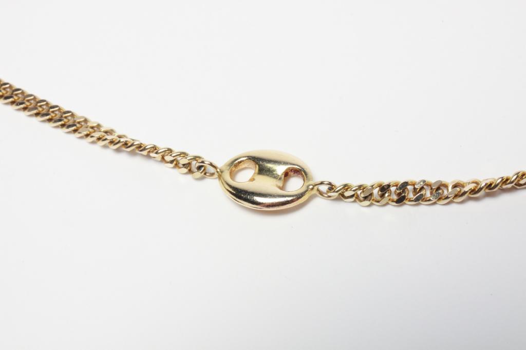 14K YELLOW GOLD CHAIN WITH GUCCI LINK STATIONS.: Italian, late 20th century. Stamped "14Kt Italy" curb link chain with eight Gucci link stations. 31"L, 28gr.