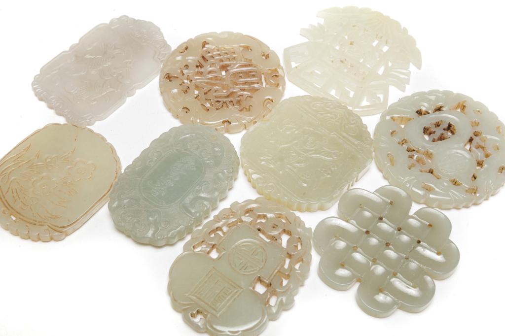 NINE CHINESE CARVED JADE PENDANTS. (1 of 2)