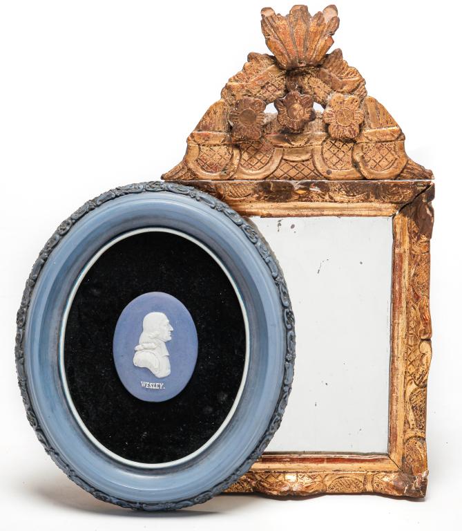EUROPEAN GILT MIRROR AND "WESLEY" MEDALLION.: Nineteenth-20th century. Gilt wormwood mirror with carved scroll frame and crest with applied flowers. Wear and repair. 21"h. 11"w. And an English Wedgwood type blue and white portrait medallion of "W