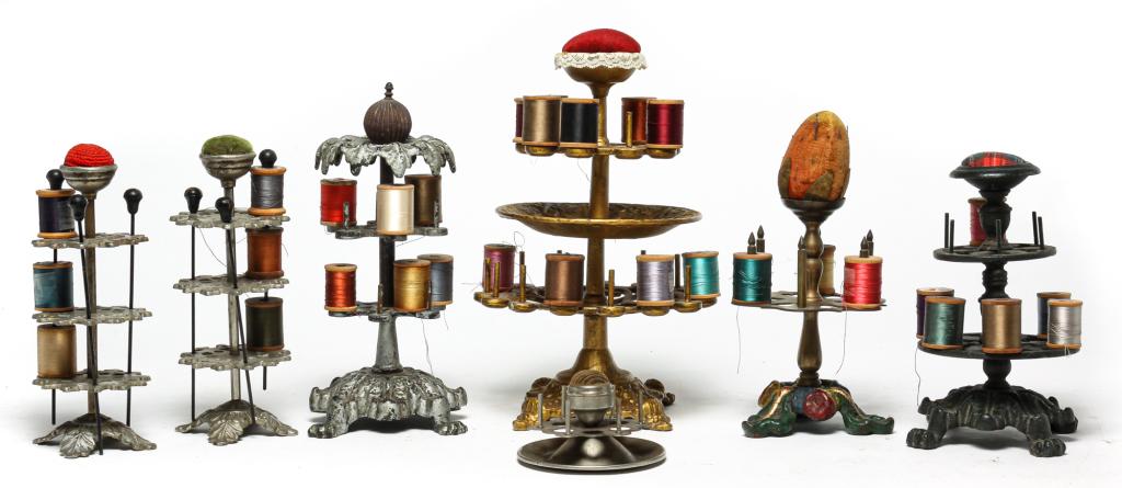 SEVEN AMERICAN METAL THREAD CADDIES. (1 of 6)