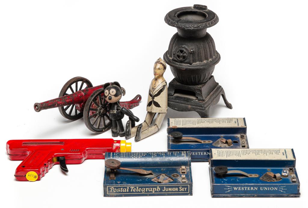 SMALL GROUP OF AMERICAN TOYS.: Twentieth century. Three tin telegraph, "Ranger Jr." cannon, "Repeater" water pistol, "Felix" the cat, tin sailor with no arms and cast iron stove, 8"h.