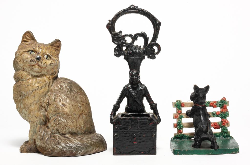 THREE AMERICAN CAST IRON DOOR STOPS. (1 of 5)
