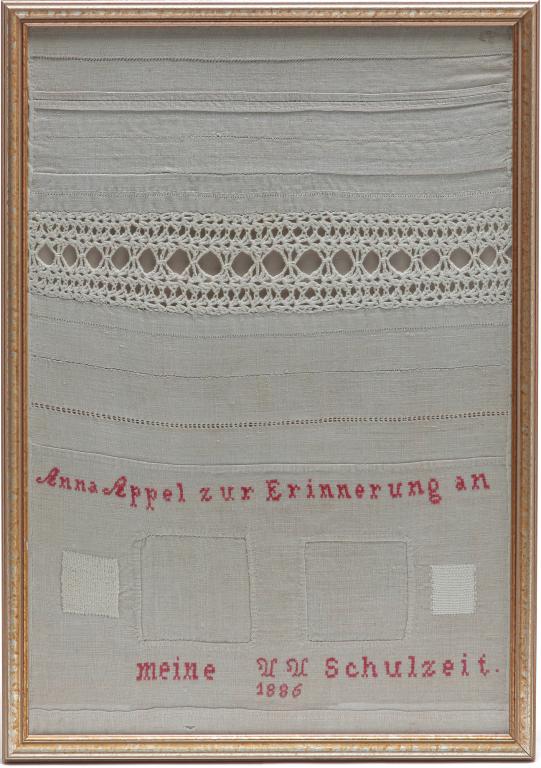 GERMAN AMERICAN SHOW TOWEL.: Dated 1886. Natural linen with different stitch and knitting examples. Lettered in German with red thread, "Anna Appel for Remembrance of my schooltime 1886." 25"h. 17.5"w.