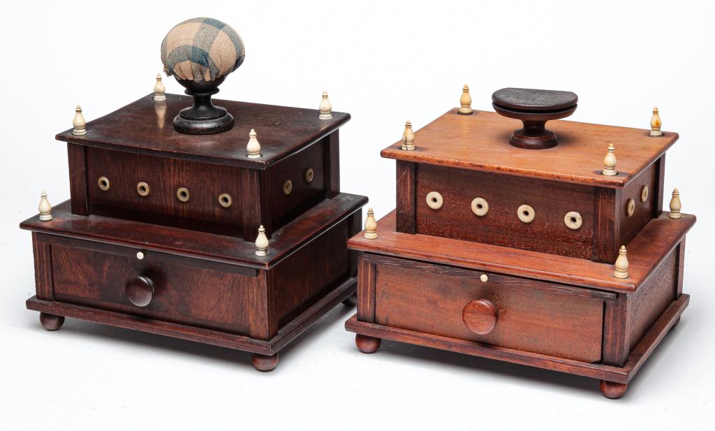TWO AMERICAN SEWING CADDIES.: Second half 19th century, mahogany and pine secondary. Both have turned bone details, fold-out mirrors, lower drawers and ball feet. Darker has pincushion top, 8"h. 7"w. 5.5"d. And lighter is missing 