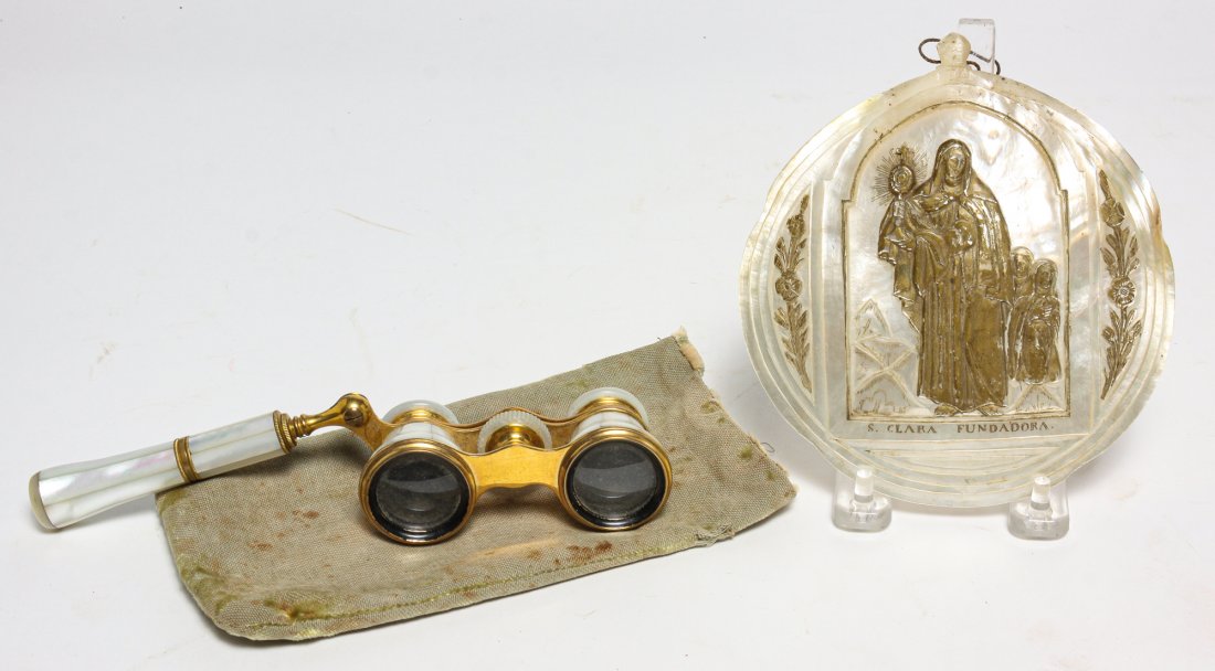 TWO EUROPEAN MOTHER OF PEARL PIECES.: Twentieth century. Colmont, Paris opera glasses with S Kind and Sons, Philadelphia retailer mark, 2"h. 4"w. And a carved shell with Sainte Clara Fundadore, 6.25"h.