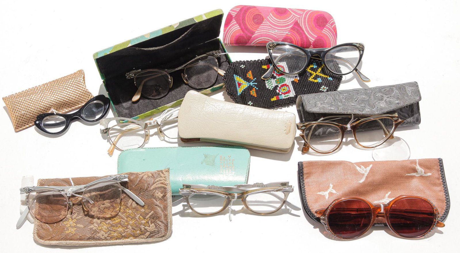 NINE PAIRS EYEGLASSES AND SUNGLASSES.: Mid 20th century. Different styles in the 1950s and 1960s period.