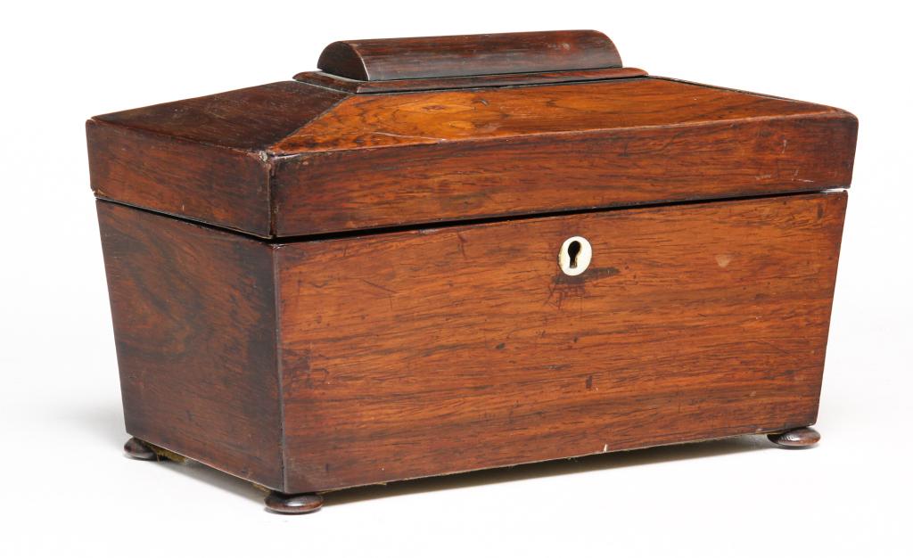 ENGLISH ROSEWOOD TEA CADDY.: First half 19th century, rosewood veneer. Sarcophagus lid, bun feet and mother of pearl escutcheon. Paper lined nterior has lidded container and a replaced glass mixing bowl. Veneer splits and some lo