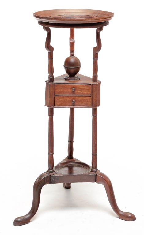ENGLISH QUEEN ANNE WASH BASIN STAND.: Third quarter 19th century, mahogany with oak secondary. Ring Top, turned lidded receptacle, two dovetailed drawers, lower shelf, snake legs and pad feet. Damage and repair. 33"h.