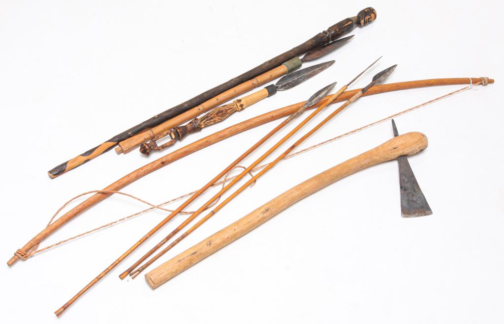 AFRICAN SPEARS, CARVED CANE, AXE AND BOW.: Twentieth century. Figural cane, most likely of ironwood, 37"l., bow, axe, 29"l., two short spears, 22", 27.5"l. and three short javelins.