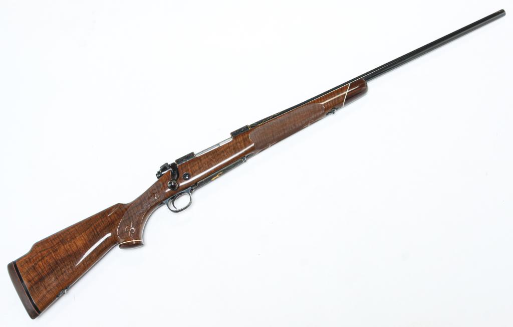 *WINCHESTER MODEL 70 CUSTOM CLASSIC RIFLE.: One of original 100 Custom Classics, being one of the first ten serial numbers. Bolt action, centerfire rifle, 338 Win. Mag., 24" barrel. Checkered grips with fleur de lys details, heavily engraved wi