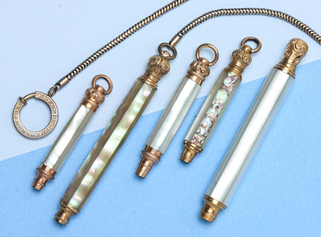 VINTAGE MOTHER OF PEARL RETRACTABLE PENCILS.: Late 19th century. Group of five retractable pencils, each with mother-of-pearl body, gold metal, four with attached suspension rings. Three marked "Pearl PAT. DEC. 5. 71", one pen with chain. Sizes r
