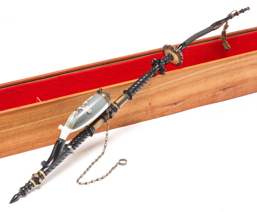 GERMAN PIPE.: Early 20th century. Porcelain bowl with hand painted image of a maid with serving tray. Horn, antler and ebonized wood stem. 28.5"l. Display case included.