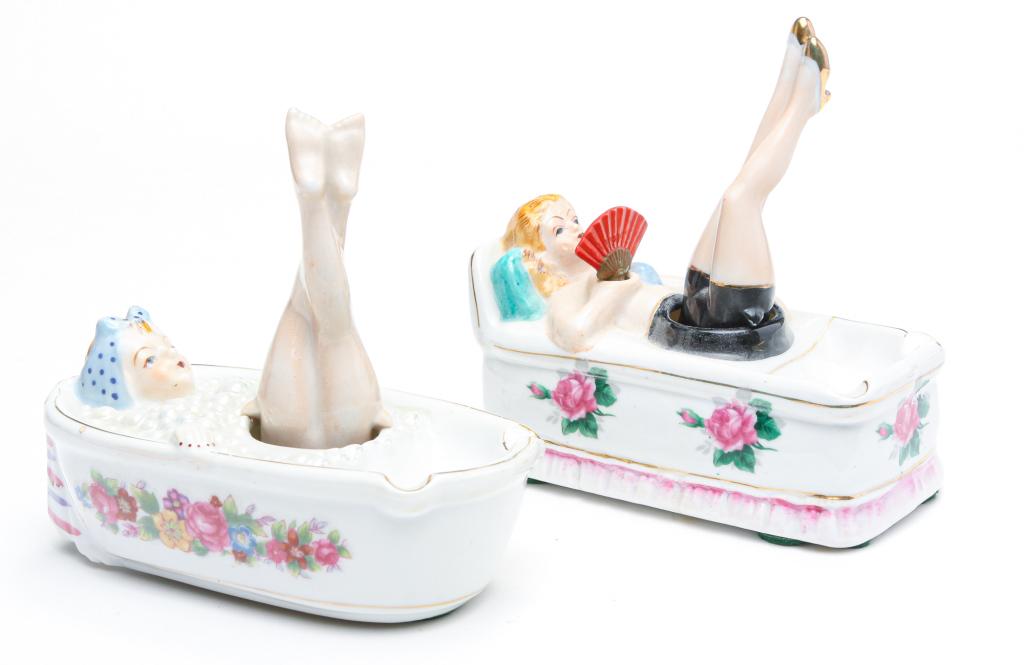 TWO JAPANESE TAKITO NAUGHTY NODDER ASHTRAYS.: Ca. 1940s-50s. Both marked "Patent T.T". Woman with a fan on day bed, and a woman in a bathtub. Hand painted. Both 5.5"l.