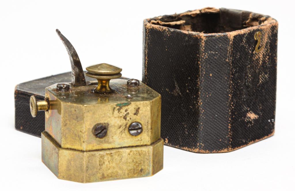 AMERICAN MULTIBLADE FLEAM.: Mid 19th century, brass and steel. Octagonal shape with spring action blades. 2.25"l. In very worn original case.