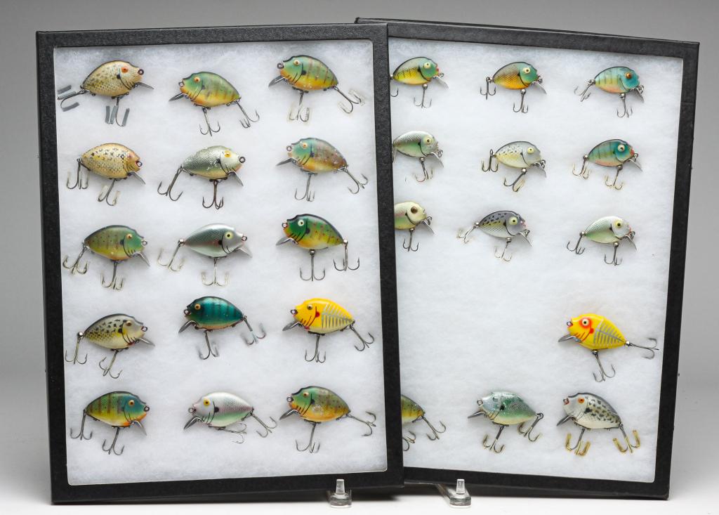 TWENTY-EIGHT HEDDON PUNKINSEED FISHING LURES.: Group of twenty-eight Heddon Punkinseed fishing lures. All are displayed in two glass top display cases.