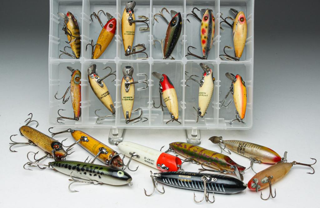 20 HEDDON FISHING LURES, SOME WOOD, GLASS EYES.: Group of twenty Heddon fishing lures. Included are twelve wooden River Runts with glass eyes, three Heddon Vamps, two Heddon Zara Spooks, a Wounded Spook, and one unmarked lure. Included are two clear