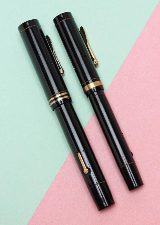TWO VINTAGE BLACK CONKLIN ENDURA FOUNTAIN PENS.: American, circa 1925. Two hard rubber fountain pens, lever fill, both with Endura nibs and stamped on lever 'PAT.NOV.17.1925' with embossed crescent. Larger pen, 5.12"l, double gold filled bands on ca