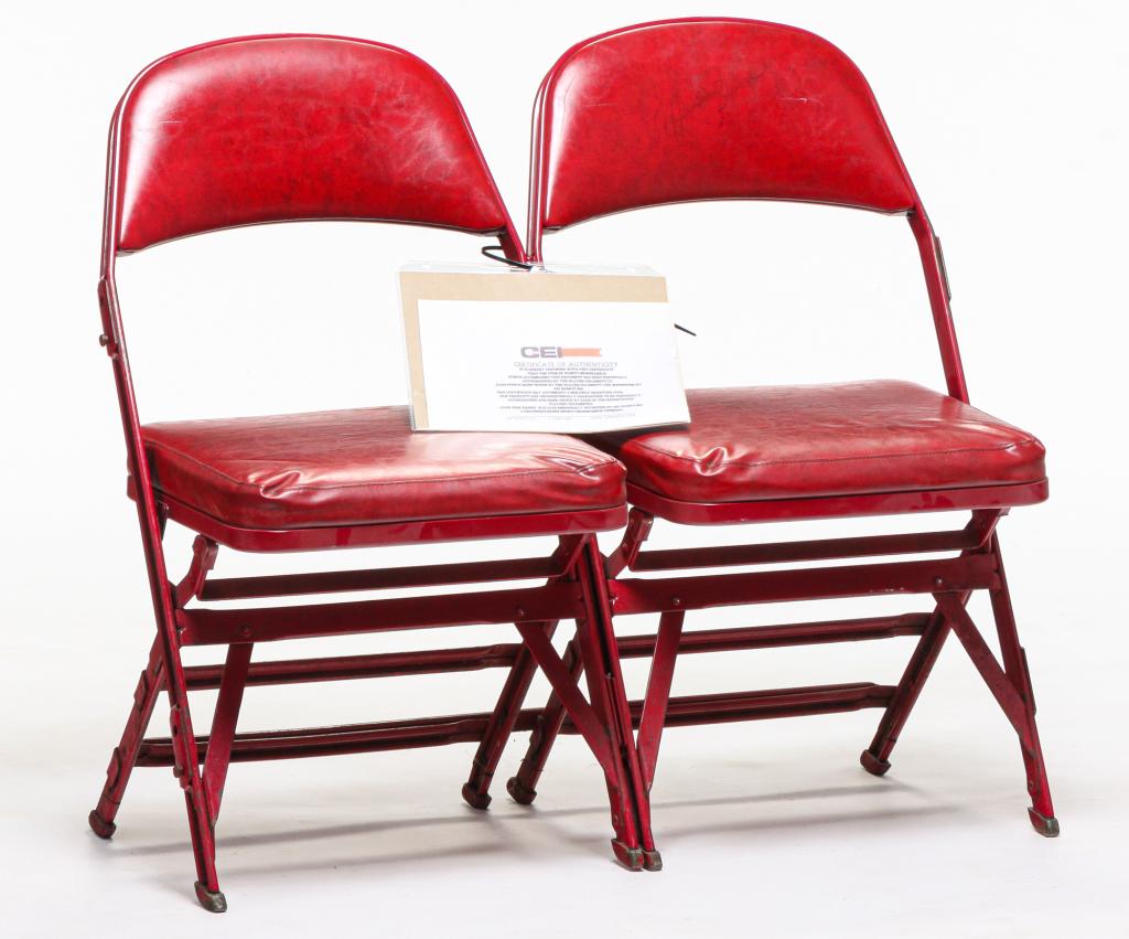 2 FOLDING STADIUM SEATS SIGNED BY MICHAEL JORDAN.: 1994. Red steel frames and red vinyl seats and backs. Signed on back rest in faded black ink. Signed by Jordan for the consignor. 17" seat. 32.5"h. 37"w.