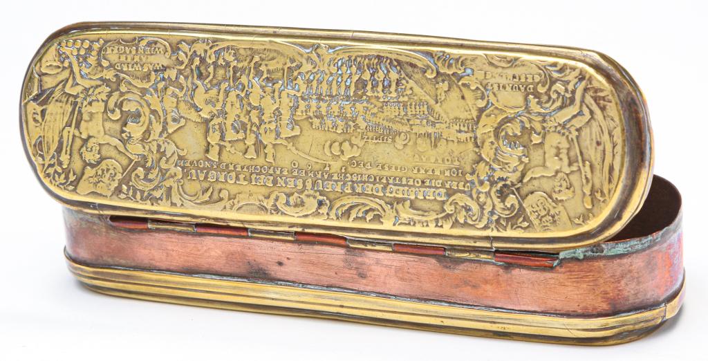 DUTCH TOBACCO BOX.: Late 18th century, copper and brass. Lid has raised battle scene of the Battle of Torgau, 1760 under Frederick the Great, while the underside has extensive text. Wear in areas from use. 6"l. Ex Dr. Sa