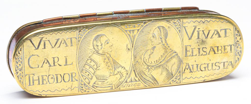 DUTCH TOBACCO BOX.: Ca. 1747, copper and brass. Engraved portraits of Elector Charles Theodore and his wife, Elisabeth Augusta, and their 1747 wedding procession. 6.5"l. Sold at Garth's November, 2016, lot 317.