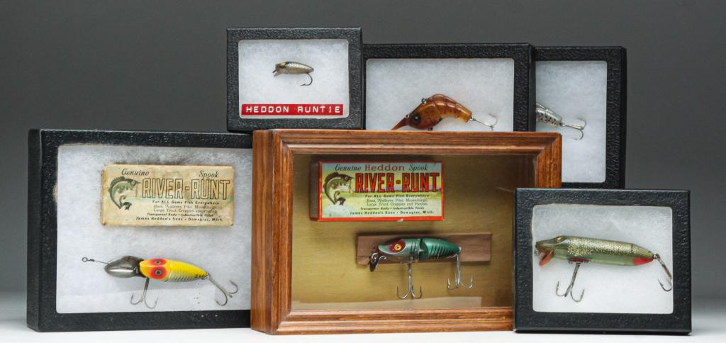 SIX HEDDON LURES IN DISPLAY CASES.: Group of six Heddon lures. Includes a Heddon Runtie, a Vamp Spook with glass eyes, two Heddon Shrimp, a River Runt Spook 2nd with original box, and a River Runt Spook with original box. All are in pro